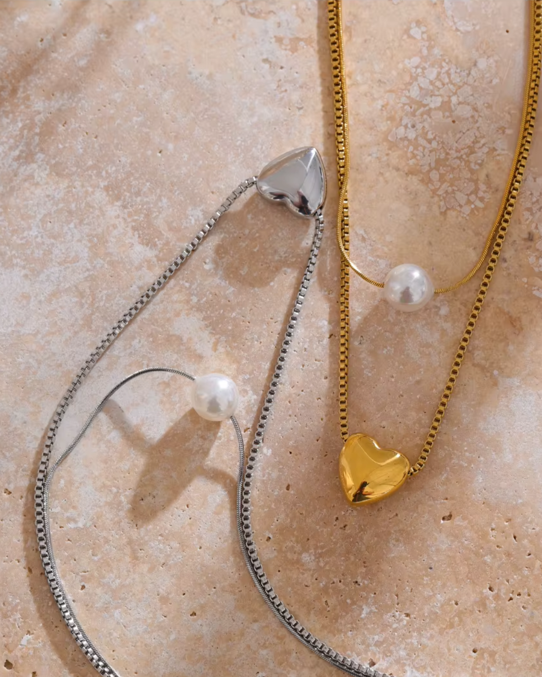 A double-layer stainless steel necklace with a delicate heart pendant and a luminous imitation pearl, featuring a rust-proof and tarnish-resistant finish for timeless elegance. 