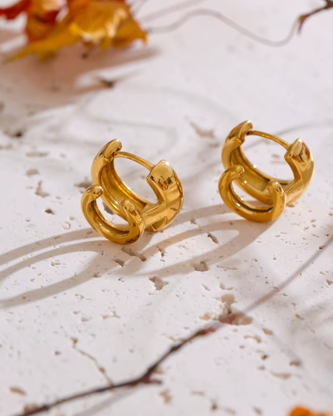 Double-layer round hoop earrings made of PVD-plated stainless steel, offering a chic golden shine and versatile design.