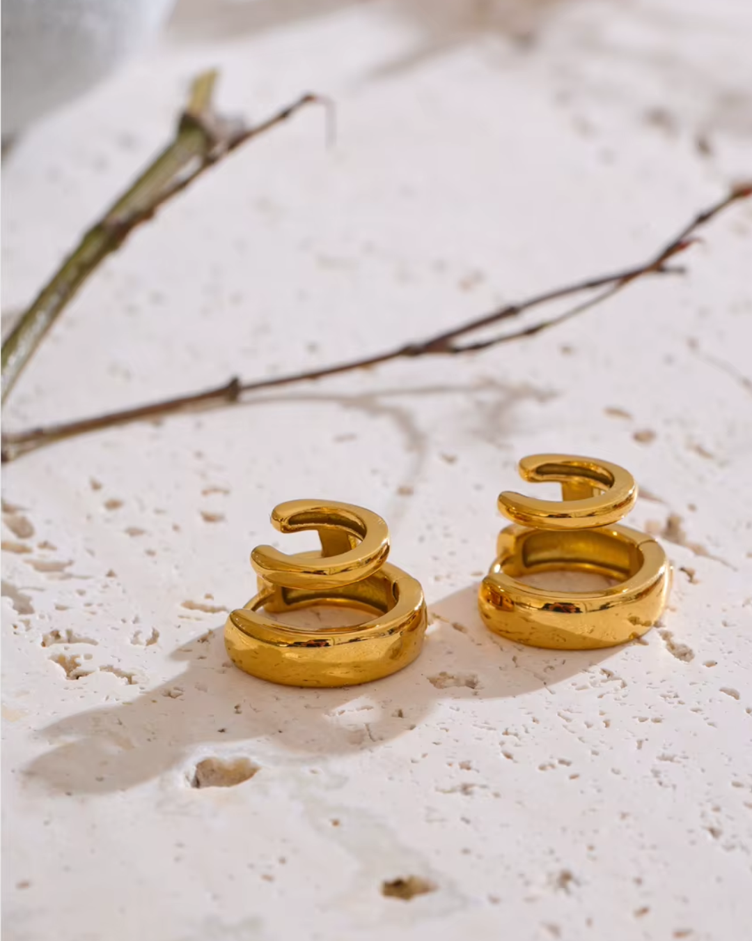 Double-layer round hoop earrings made of PVD-plated stainless steel, offering a chic golden shine and versatile design.