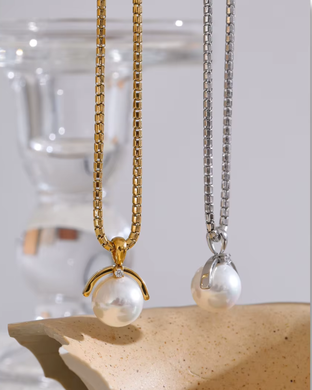 A silver stainless steel necklace featuring an elegant round simulated pearl pendant, with a tarnish-resistant finish for a timeless and versatile look.