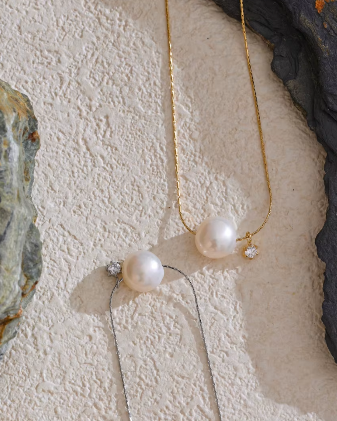 A silver and gold  stainless steel necklace with a luminous freshwater pearl and sparkling zircon pendant, offering a tarnish-resistant, timeless design for effortless elegance.