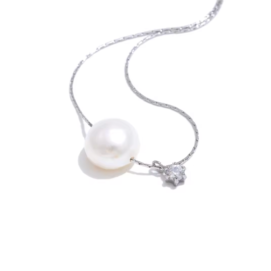 A silver stainless steel necklace with a luminous freshwater pearl and sparkling zircon pendant, offering a tarnish-resistant, timeless design for effortless elegance.