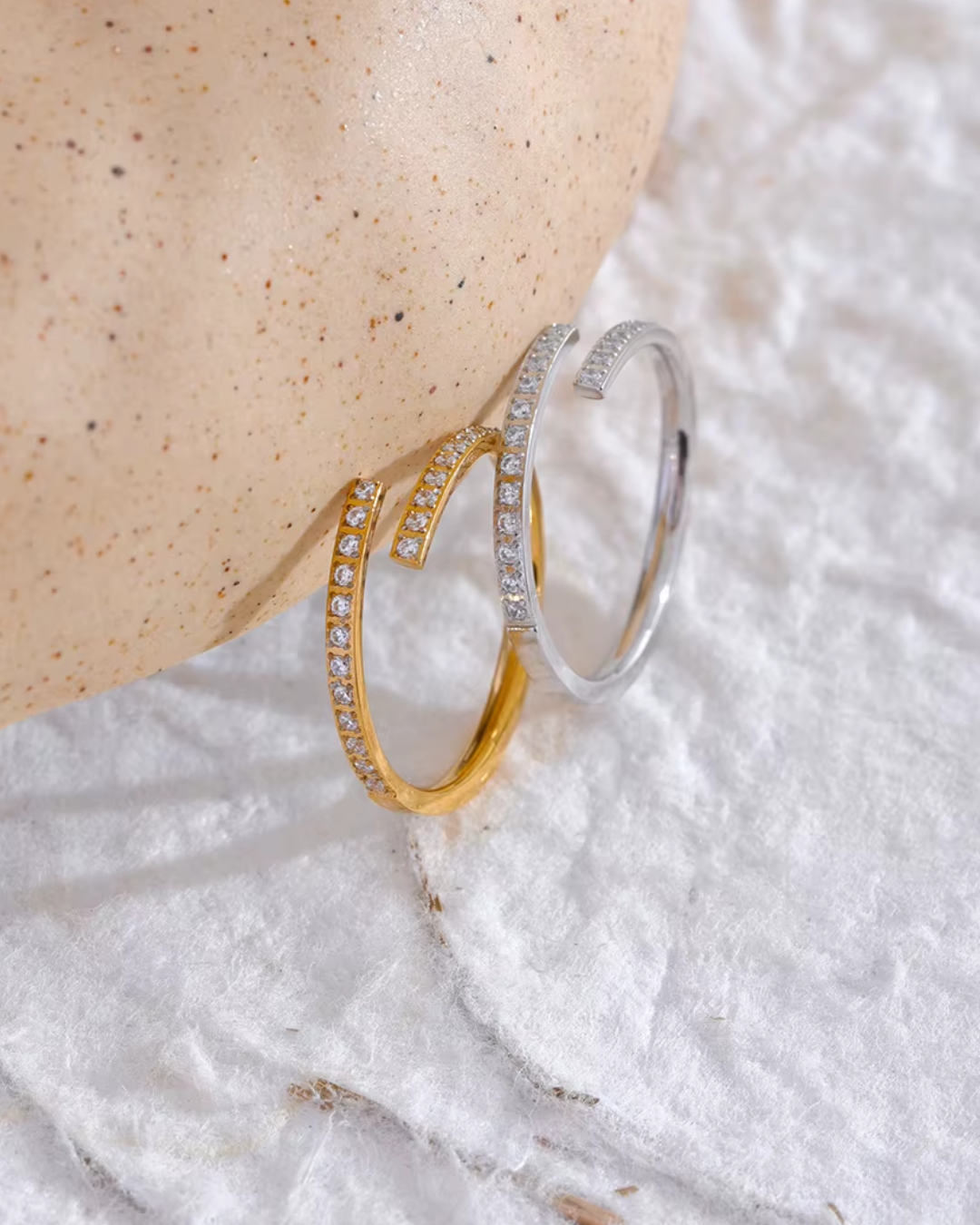 A minimalistic open ring made of stainless steel, featuring a sparkling cubic zirconia stone. The sleek design offers an adjustable fit and is waterproof, perfect for adding a touch of elegance to any look.